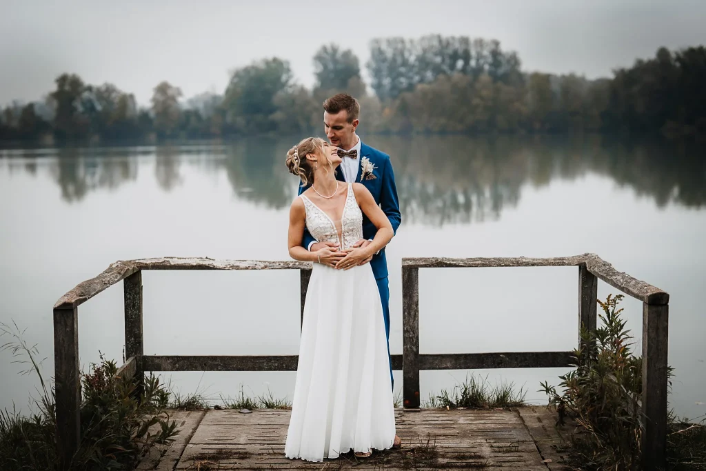 Natürliche Hochzeitsfotos am See, Brautpaar lächelt sich verliebt an, Hochzeitsfotograf Straubing, Hochzeitsfotograf Passau